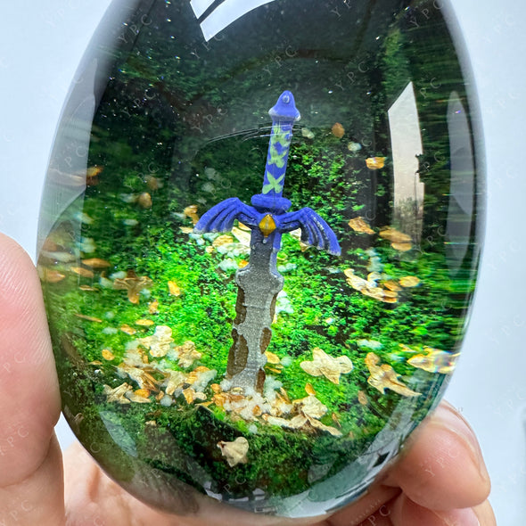 A resin and wood egg with a rusty master sword inside and a wooden stand to display it. Inspired by The Legend of Zelda games