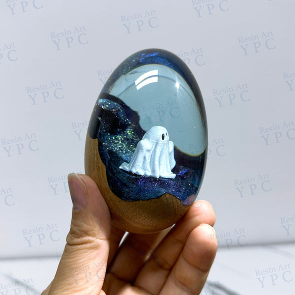 Ghost Egg, a resin and wood egg shape with stand with a ghost inside.
