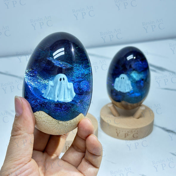 Ghost Egg, a resin and wood egg shape with stand with a ghost inside.